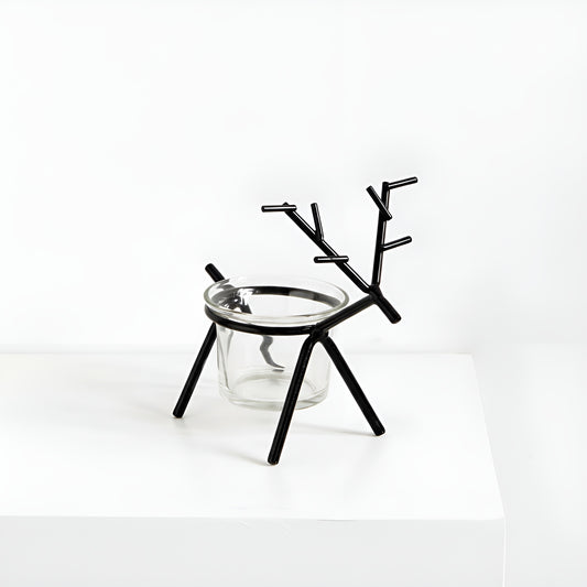 Black deer-shaped candle holder with a glass base on a white background