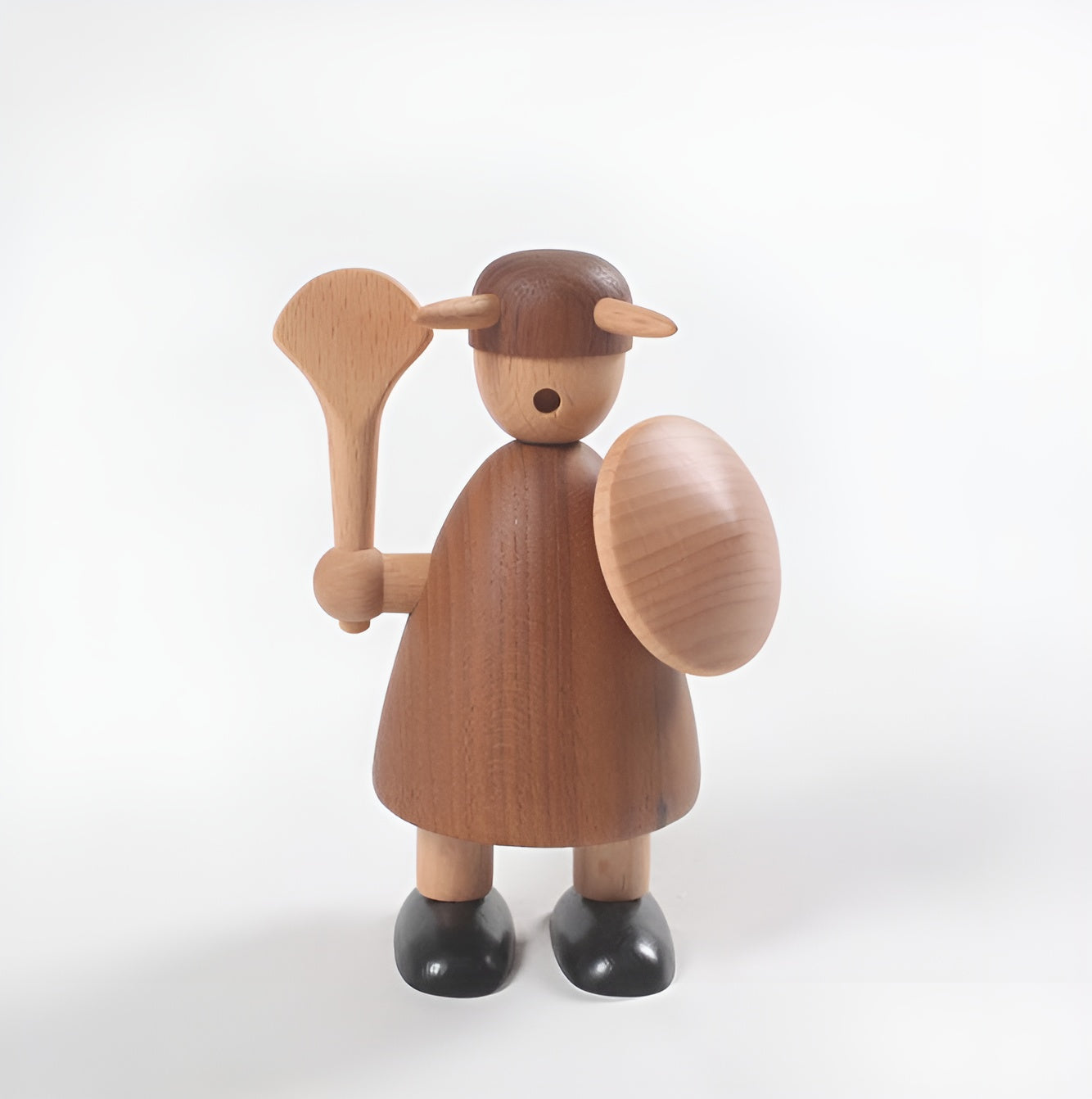 Wooden figurine of a character with a shield and spear on a white background